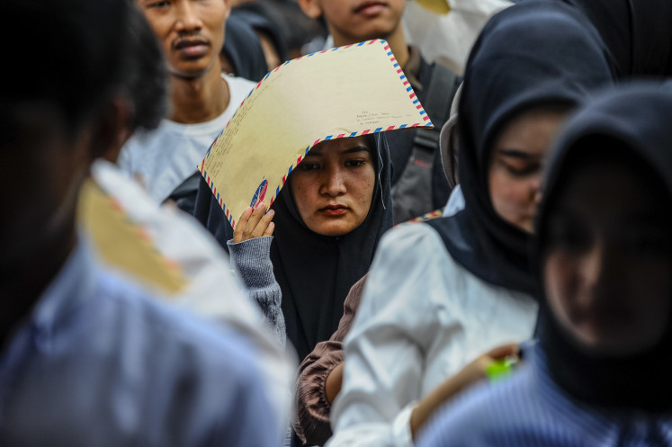 Jobseekers line up on May 14, 2024, to file their employment applications
during a job fair in Pandeglang, Banten, which featured 16 companies. The fair was part of
the provincial government’s effort to help young people find employment.